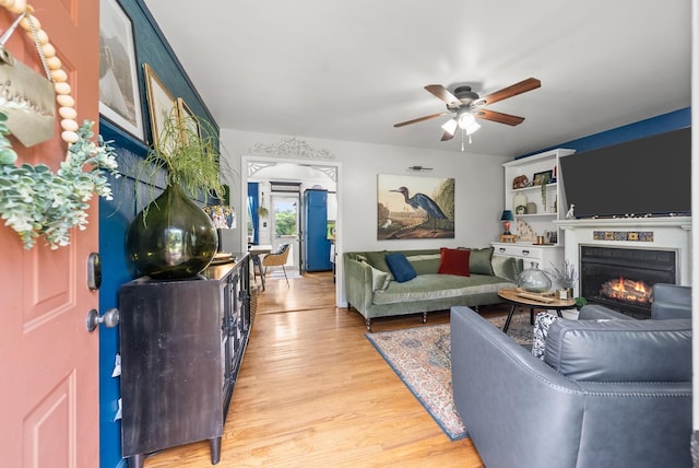 1805 Needmore Rd, Clarksville, TN 37042 - living room with light wood finished floors, ceiling fan, and a lit fireplace