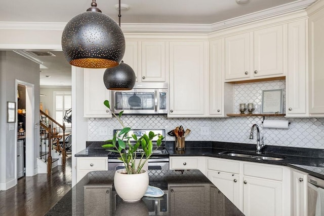 6067 Keats St, Franklin, TN 37064 - kitchen featuring stainless steel microwave, range, dark stone countertops, wood finished floors, and ornamental molding