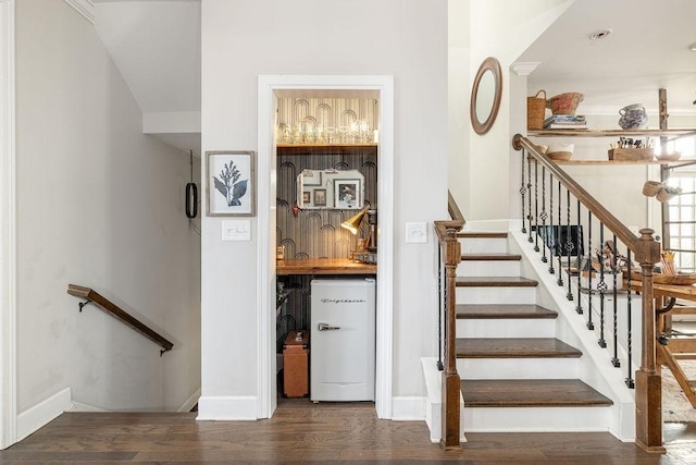 6067 Keats St, Franklin, TN 37064 - staircase featuring wood finished floors and bar