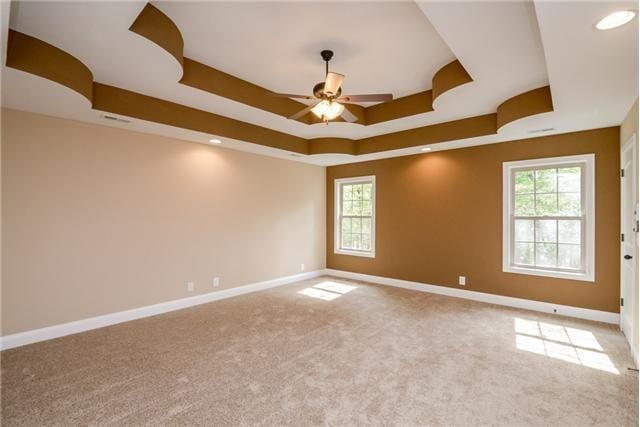 1789 Double R Blvd, Clarksville, TN 37042 - carpeted empty room featuring ceiling fan, a raised ceiling, and healthy amount of natural light