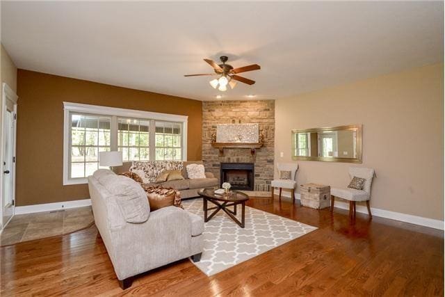 1789 Double R Blvd, Clarksville, TN 37042 - living area with a ceiling fan, a large fireplace, and wood finished floors