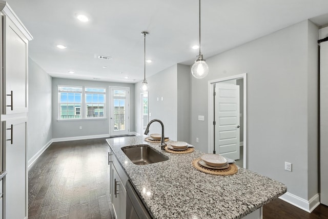 1000 Vintage Green Ln Unit 1201, Franklin, TN 37064 - kitchen featuring dark wood-style flooring, recessed lighting, white cabinets, light stone counters, and an island with sink