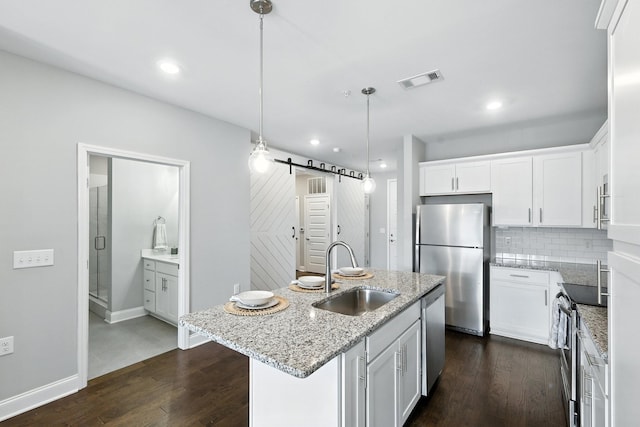1000 Vintage Green Ln Unit 1201, Franklin, TN 37064 - kitchen with stainless steel appliances, dark wood-style floors, an island with sink, white cabinets, and tasteful backsplash