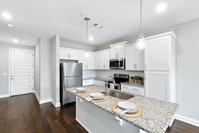1000 Vintage Green Ln Unit 1201, Franklin, TN 37064 - kitchen with appliances with stainless steel finishes, backsplash, a center island with sink, white cabinets, and recessed lighting