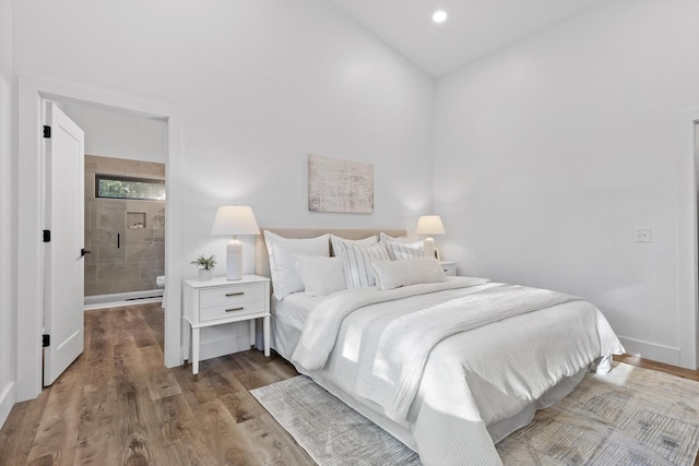 263 Eleanor Dr SW, Cleveland, TN 37311 - bedroom featuring wood finished floors, vaulted ceiling, and ensuite bath