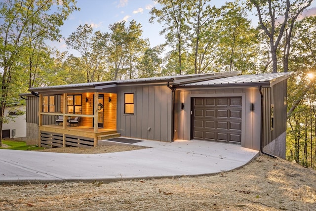 263 Eleanor Dr SW, Cleveland, TN 37311 - view of front of home with a garage, concrete driveway, a metal roof, and a porch