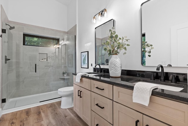 263 Eleanor Dr SW, Cleveland, TN 37311 - full bathroom featuring double vanity, a shower stall, and wood finished floors