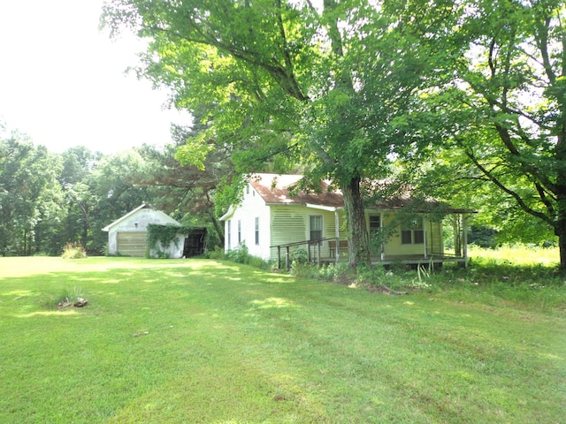 2625 Old Blacktop Rd, Mc Ewen, TN 37101 - view of green lawn featuring a detached garage and an outdoor structure