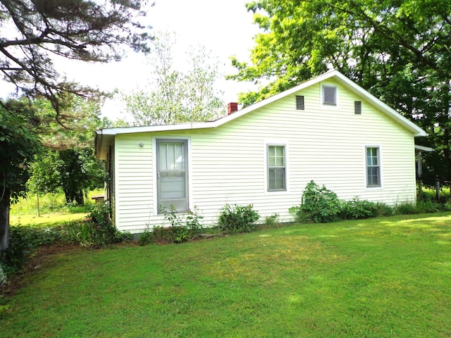 2625 Old Blacktop Rd, Mc Ewen, TN 37101 - back of house featuring a yard and a chimney