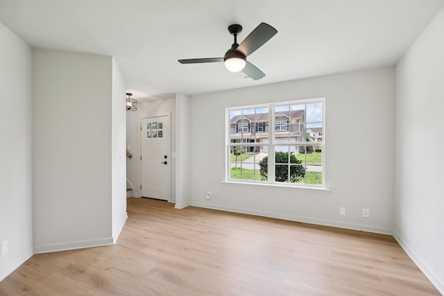 1033 Tom Hailey Blvd, La Vergne, TN 37086 - spare room with light wood-type flooring, stairs, and a ceiling fan