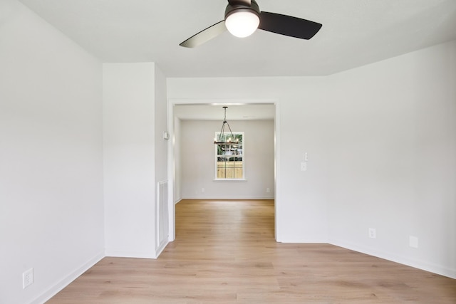 1033 Tom Hailey Blvd, La Vergne, TN 37086 - spare room featuring a ceiling fan, light wood-style floors, and a chandelier