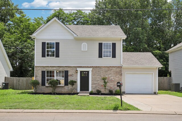 1033 Tom Hailey Blvd, La Vergne, TN 37086 - view of front facade with a garage, concrete driveway, brick siding, and roof with shingles