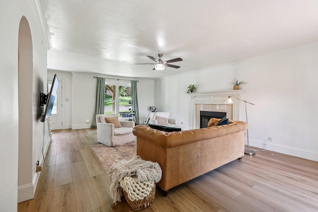 121 La View Rd, Hendersonville, TN 37075 - living room featuring light wood-style flooring, arched walkways, a ceiling fan, and a tiled fireplace