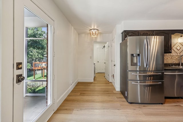121 La View Rd, Hendersonville, TN 37075 - kitchen featuring stainless steel fridge with ice dispenser, dark brown cabinetry, light wood-style flooring, dark countertops, and backsplash