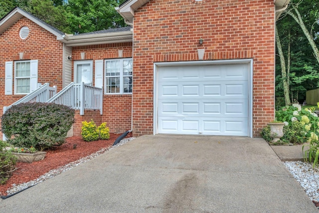 237 Woodmaker Ct, Nashville, TN 37214 - view of front facade featuring brick siding, driveway, and an attached garage