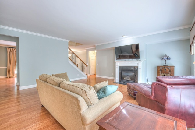 1222 Broadmoor Cir, Franklin, TN 37067 - living room with stairway, light wood-style floors, crown molding, and a fireplace