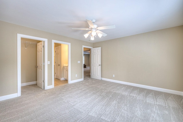1222 Broadmoor Cir, Franklin, TN 37067 - unfurnished bedroom featuring light carpet, a walk in closet, a closet, ceiling fan, and connected bathroom