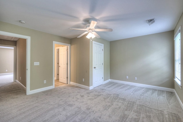 1222 Broadmoor Cir, Franklin, TN 37067 - unfurnished bedroom with light colored carpet, attic access, multiple windows, and ceiling fan