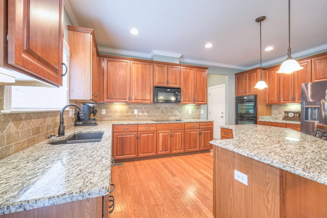 1222 Broadmoor Cir, Franklin, TN 37067 - kitchen featuring black appliances, light stone countertops, ornamental molding, decorative backsplash, and brown cabinets