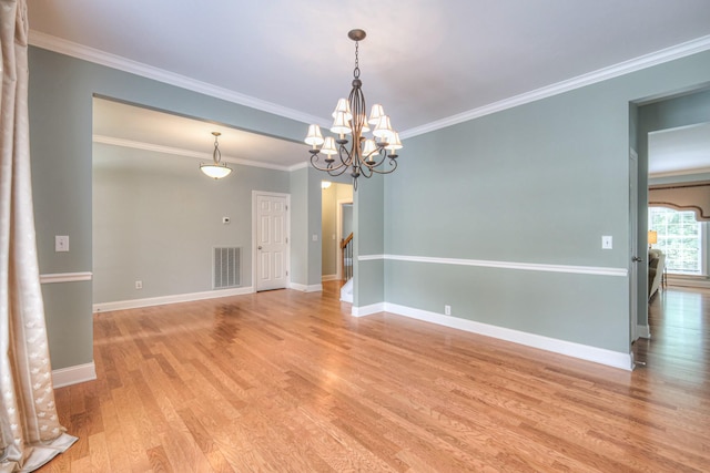 1222 Broadmoor Cir, Franklin, TN 37067 - empty room with light wood-style floors, ornamental molding, and a chandelier