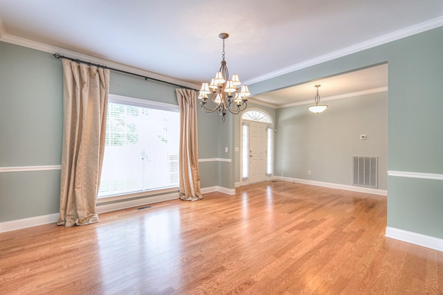 1222 Broadmoor Cir, Franklin, TN 37067 - spare room with a chandelier, light wood-style floors, and crown molding