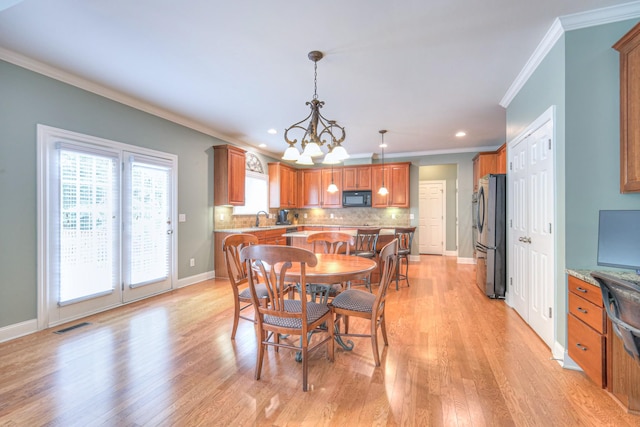 1222 Broadmoor Cir, Franklin, TN 37067 - dining room featuring crown molding, a chandelier, light wood finished floors, and recessed lighting