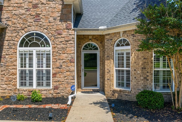 1057 Nealcrest Cir, Spring Hill, TN 37174 - view of exterior entry with roof with shingles, stone siding, and brick siding