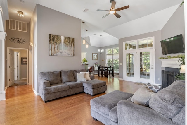 1057 Nealcrest Cir, Spring Hill, TN 37174 - living area featuring high vaulted ceiling, a ceiling fan, a fireplace, light wood-style floors, and a chandelier