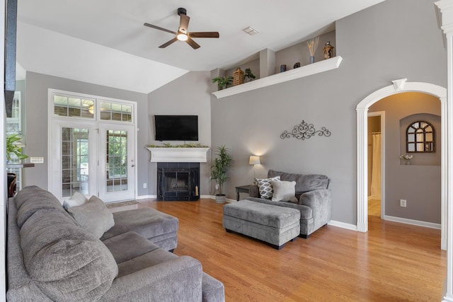 1057 Nealcrest Cir, Spring Hill, TN 37174 - living area with a ceiling fan, high vaulted ceiling, a tiled fireplace, light wood-style flooring, and arched walkways