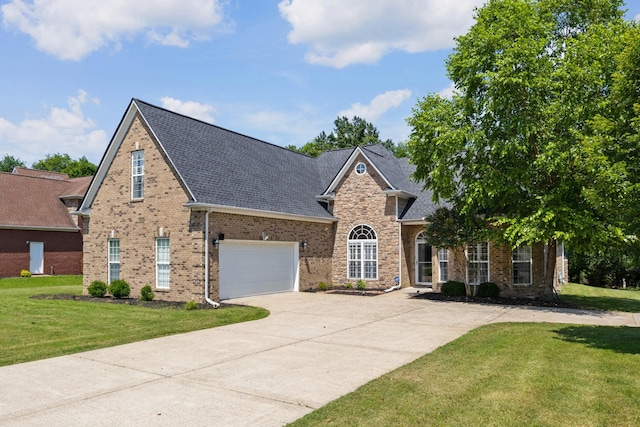 1057 Nealcrest Cir, Spring Hill, TN 37174 - traditional-style house with concrete driveway, a front yard, a shingled roof, brick siding, and a garage