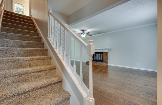 1524 Stone Hill Rd, Mount Juliet, TN 37122 - stairway featuring wood finished floors, a textured ceiling, a ceiling fan, and ornamental molding
