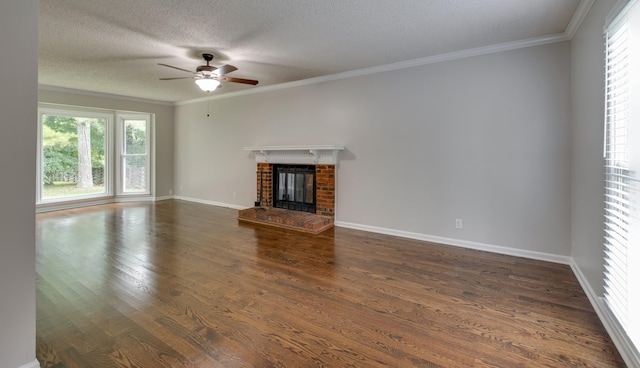 1524 Stone Hill Rd, Mount Juliet, TN 37122 - unfurnished living room with a ceiling fan, dark wood-style floors, ornamental molding, a brick fireplace, and a textured ceiling