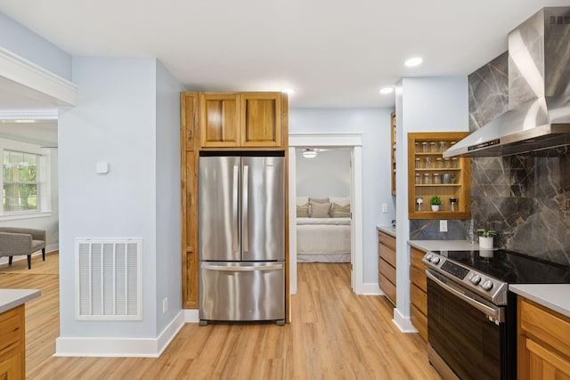 1237 Abiff Rd, Bon Aqua, TN 37025 - kitchen featuring appliances with stainless steel finishes, wall chimney range hood, light wood-type flooring, backsplash, and open shelves