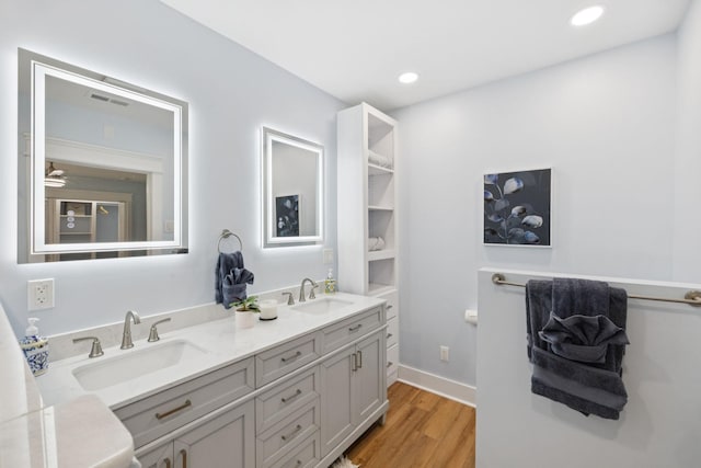 1237 Abiff Rd, Bon Aqua, TN 37025 - full bathroom featuring wood finished floors, double vanity, recessed lighting, and ceiling fan