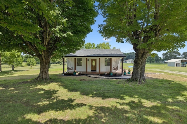 1237 Abiff Rd, Bon Aqua, TN 37025 - view of front of house featuring board and batten siding, covered porch, and a front lawn