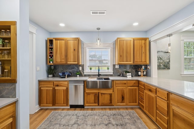 1237 Abiff Rd, Bon Aqua, TN 37025 - kitchen with light wood finished floors, dishwasher, tasteful backsplash, hanging light fixtures, and light countertops