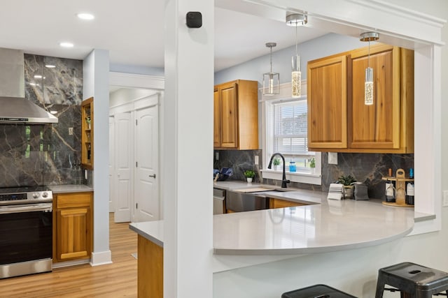 1237 Abiff Rd, Bon Aqua, TN 37025 - kitchen featuring stainless steel appliances, wall chimney exhaust hood, decorative backsplash, light wood-style floors, and recessed lighting