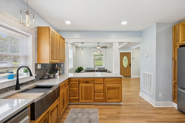1237 Abiff Rd, Bon Aqua, TN 37025 - kitchen with light wood-style flooring, a peninsula, light countertops, decorative light fixtures, and recessed lighting