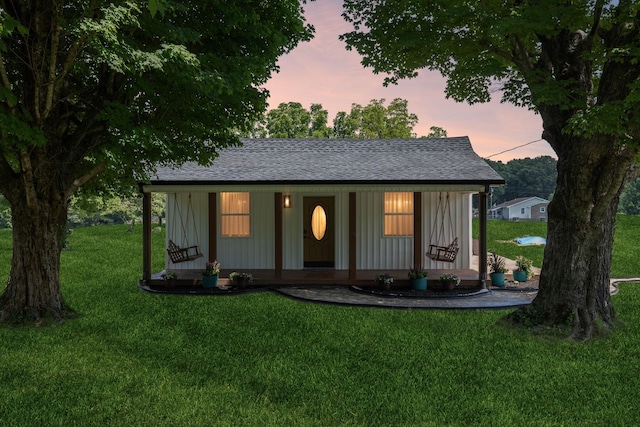1237 Abiff Rd, Bon Aqua, TN 37025 - view of front facade featuring a shingled roof, a front lawn, and covered porch