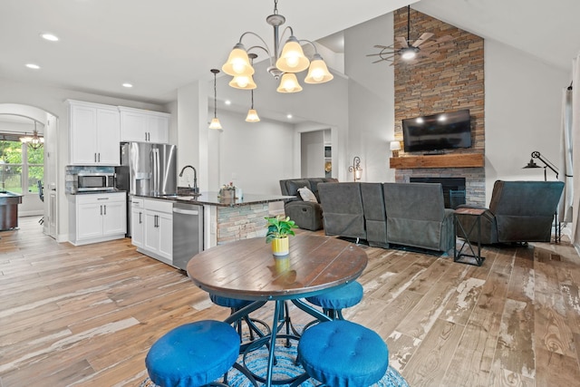 2957 Stewart Campbell Pt, Spring Hill, TN 37174 - dining room featuring a chandelier, light wood-style flooring, arched walkways, a ceiling fan, and recessed lighting