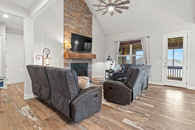 2957 Stewart Campbell Pt, Spring Hill, TN 37174 - living area with a stone fireplace, wood-type flooring, a ceiling fan, and high vaulted ceiling