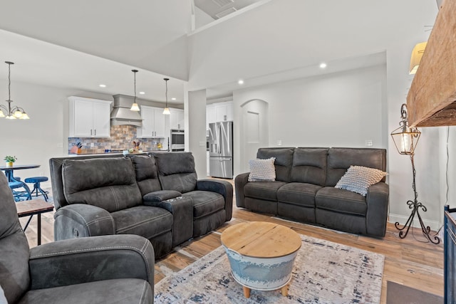 2957 Stewart Campbell Pt, Spring Hill, TN 37174 - living area with light wood-type flooring, arched walkways, a chandelier, and recessed lighting