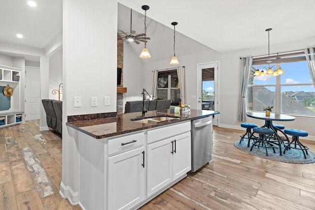 2957 Stewart Campbell Pt, Spring Hill, TN 37174 - kitchen with stainless steel dishwasher, light wood-style flooring, a ceiling fan, a chandelier, and dark stone countertops