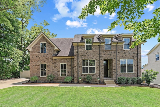 2957 Stewart Campbell Pt, Spring Hill, TN 37174 - view of front of home featuring brick siding, a front yard, and a shingled roof