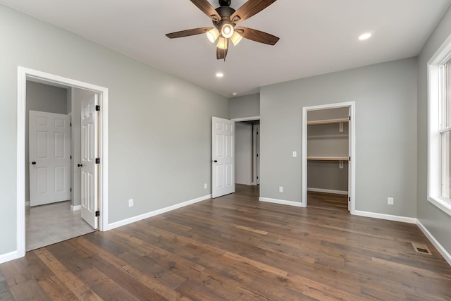 1554 Duncans Chapel Rd, Cookeville, TN 38506 - unfurnished bedroom with dark wood-type flooring, recessed lighting, a walk in closet, and a ceiling fan