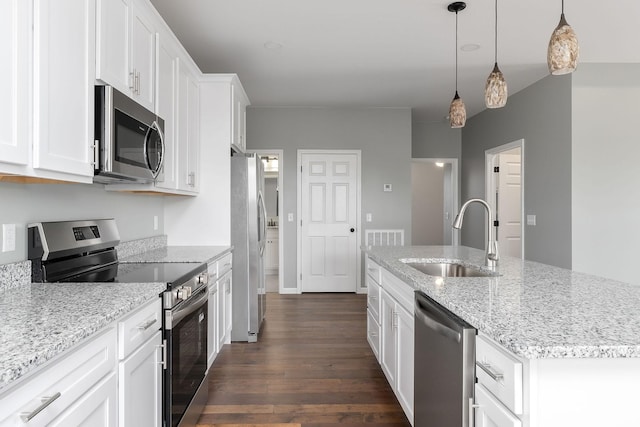 1554 Duncans Chapel Rd, Cookeville, TN 38506 - kitchen with stainless steel appliances, dark wood-type flooring, white cabinetry, a kitchen island with sink, and light stone counters