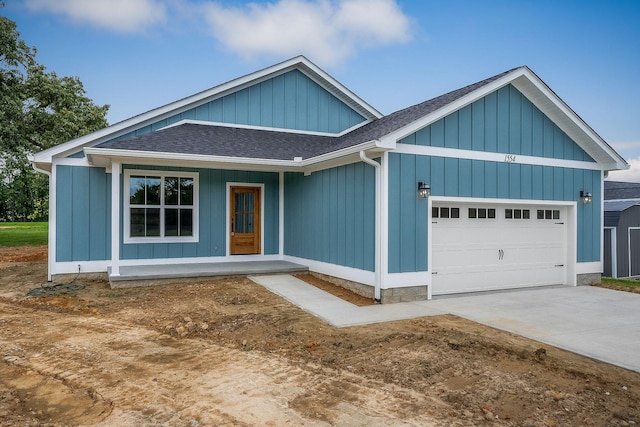 1554 Duncans Chapel Rd, Cookeville, TN 38506 - view of front facade featuring a shingled roof, an attached garage, covered porch, and concrete driveway