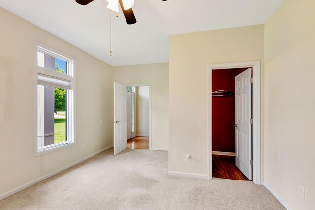 822 Old Jefferson Pike, Smyrna, TN 37167 - unfurnished bedroom featuring carpet, a walk in closet, a closet, and a ceiling fan