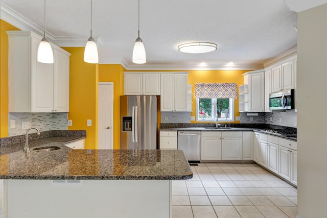 822 Old Jefferson Pike, Smyrna, TN 37167 - kitchen with stainless steel appliances, a peninsula, ornamental molding, decorative backsplash, and decorative light fixtures