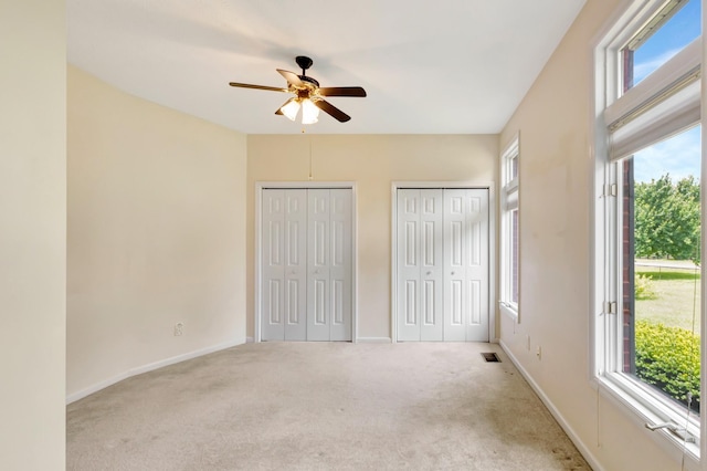 822 Old Jefferson Pike, Smyrna, TN 37167 - unfurnished bedroom with carpet flooring, multiple windows, two closets, and a ceiling fan